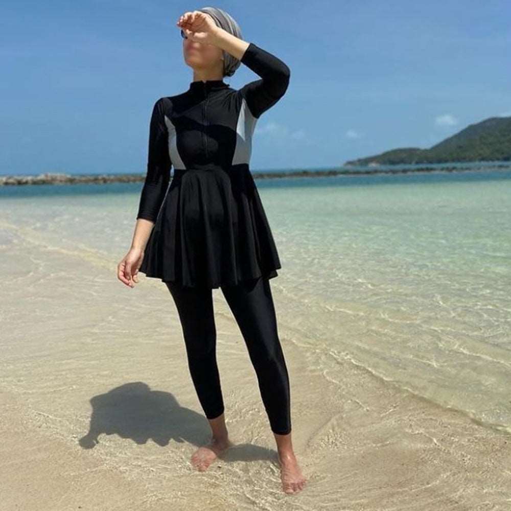 "modest swimwear. black pants with black dress, zip on front."
