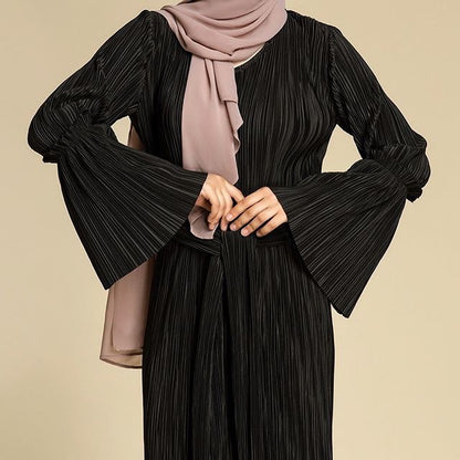 " Black maxi dress with folds and trumpet sleeves."