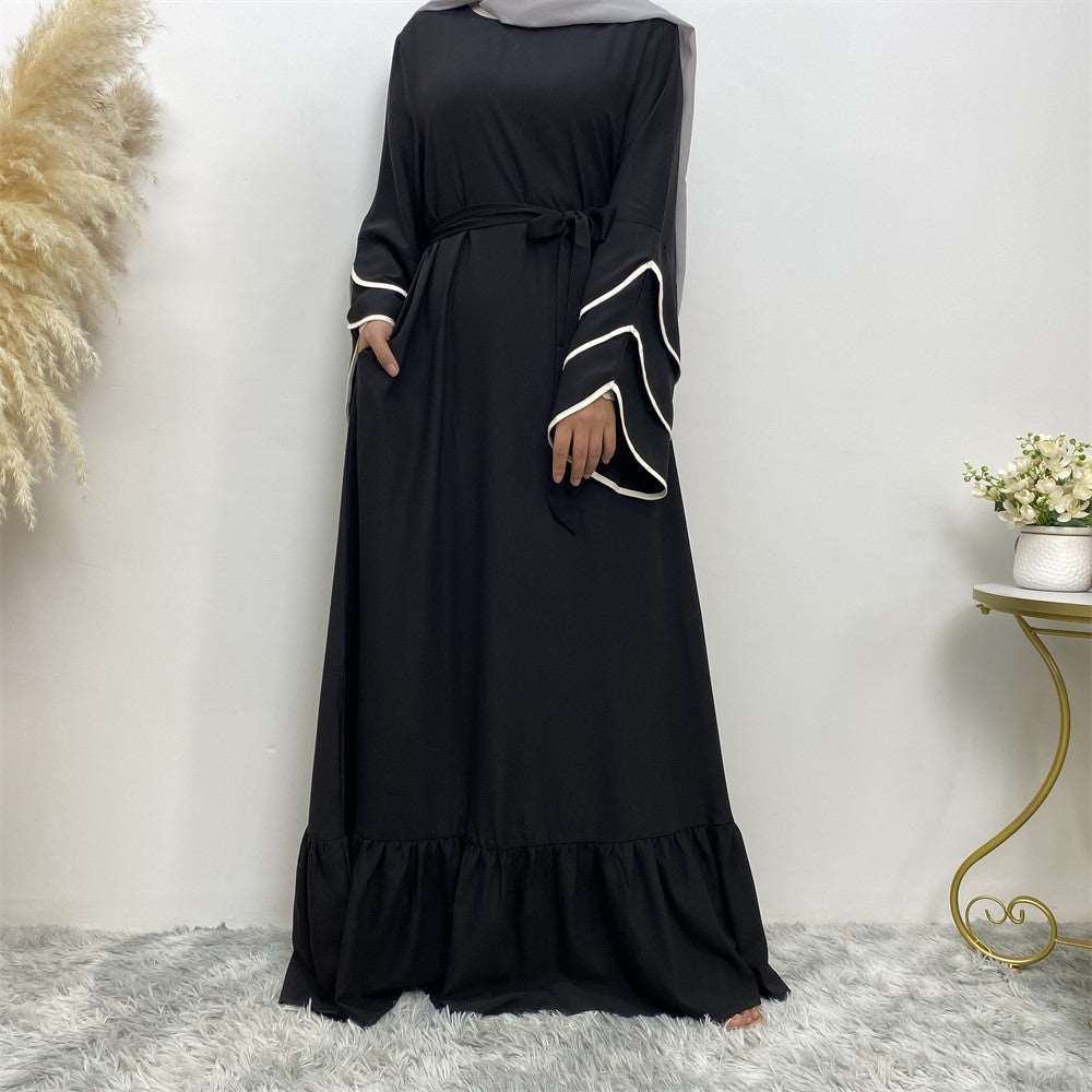 "Heba Abaya, Black abaya dress with white accents on sleeves.""