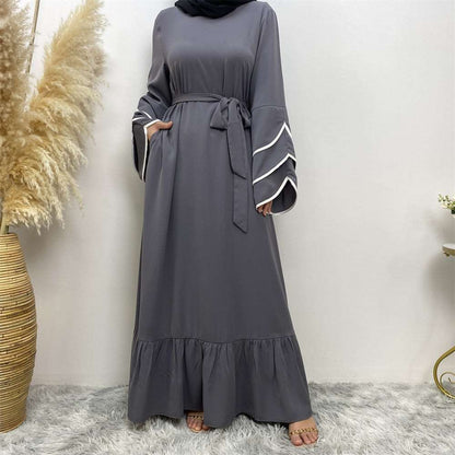 "Grey Abaya dress, pleats and white details."