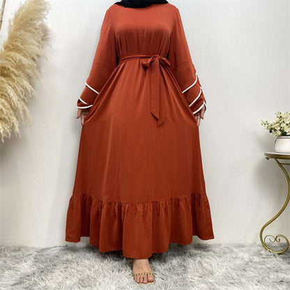 "Orange Abaya dress, pleats and white details."