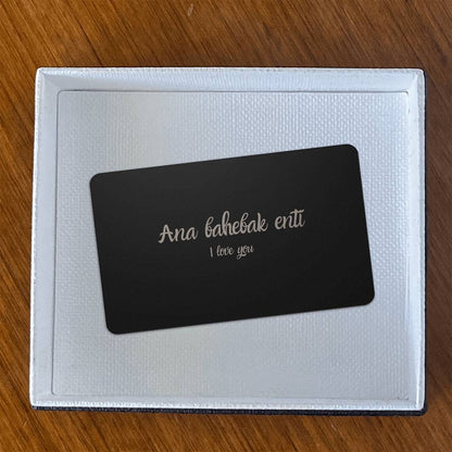 Hallafa This beautiful I Love You wallet card for her features a heartfelt message in Arabic, "Ana bahebak enti," allowing your loved one to carry a reminder of your love wherever they go. Made from durable material and with an elegant brushed black finish, this card is both sophisticated and durable. Surprise your loved one today with this lasting reminder of your affection.