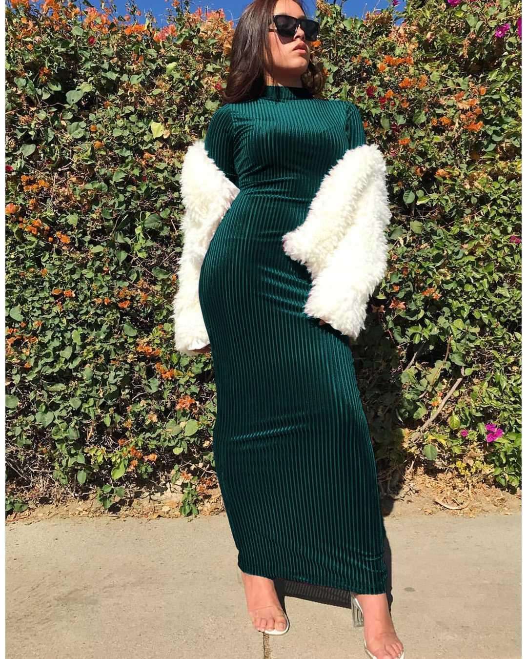 "Dark green velevt maxi dress with long sleeves."