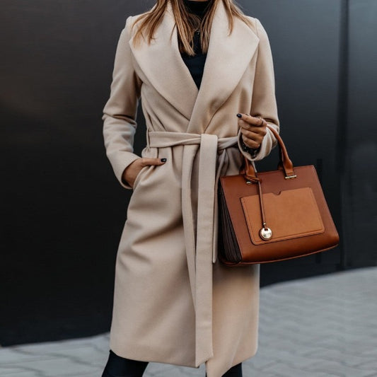 "beige Women casual jacket with belt and pockets on side."